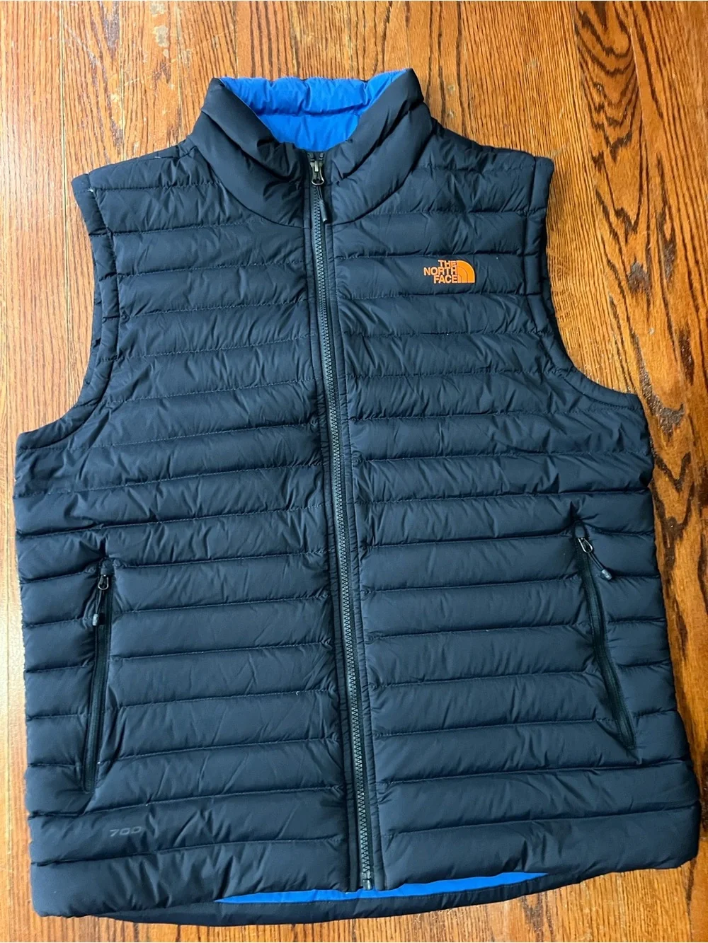 The North Face Black Quilted Down Vest with Blue Lining and Orange Logo